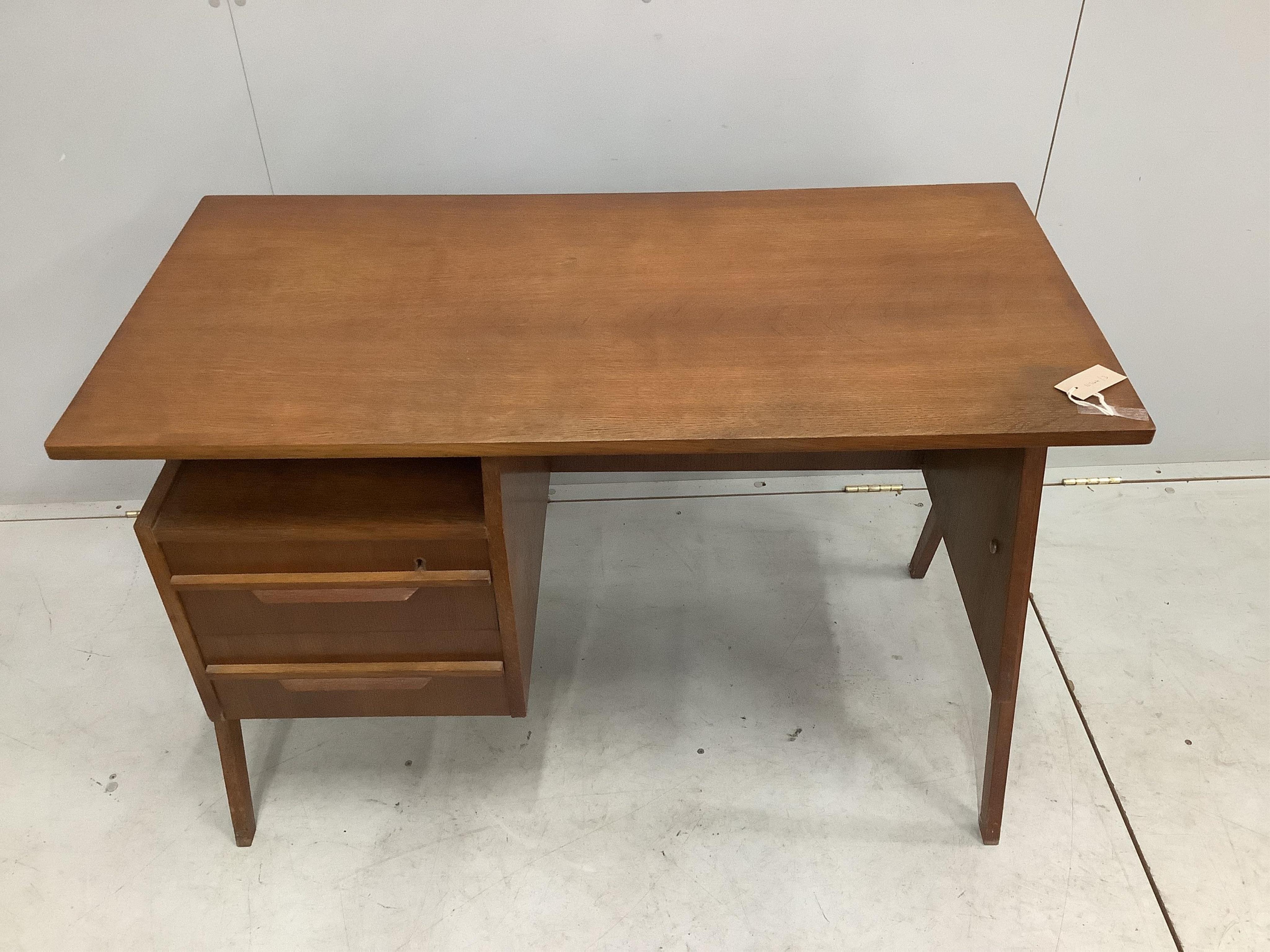 In the manner of Robin Day, a 'Hillstak' type oak desk, width 110cm, depth 55cm, height 71cm. Condition - fair